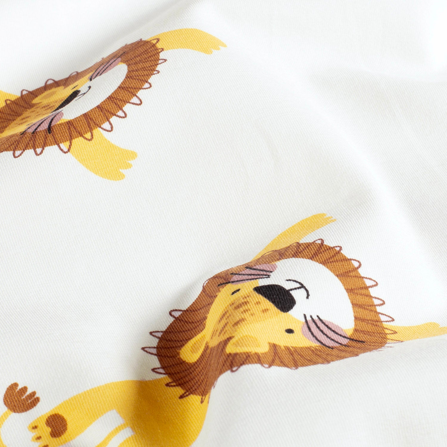 Kinderjersey mit fröhlichen Löwen. Weicher, elastischer Baumwolljersey, ideal für Shirts, Hosen, Kleider und Pyjamas.